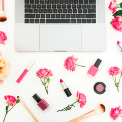 Laptop, flowers, cosmetics isolated on white background. Flat lay. Top view.