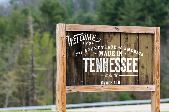 Walnut Hill, USA - April 19, 2018: Welcome to Tennessee sign at border with wooden board and text for soundtrack of America and hashtag