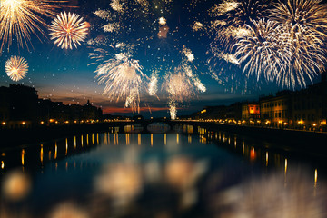 Long exposure night photography of the Ponte Vecchio, Florence-Italy and fireworks.