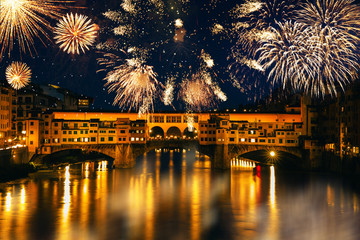 Long exposure night photography of the Ponte Vecchio, Florence-Italy and fireworks. 