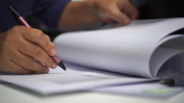 Businessman executive signing on official document paperwork files contract on office table for approval management of responsible, signature concept.