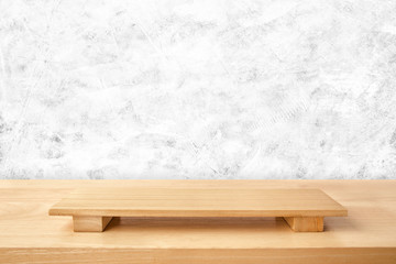 Empty sushi board on wood table with white cement texture background. Top view of plank wood for graphic stand product, interior design or montage display your product.