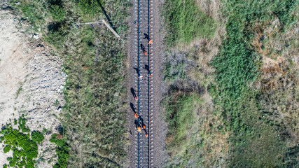Vertical aerial top down view shot on  the workers which inspect and repair railway tracks. Sukhyi...