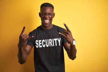 African american safeguard man wearing security uniform over isolated yellow background shouting...