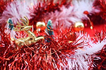 Red and white tinsel with christmas ornaments