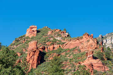 Slide Rock State Park in Arizona low angle landscape of red stone hillside and greenery
