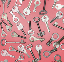 Keys set on pink background. Door lock keys and safes for proper