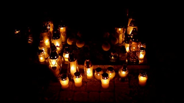Commemorative Candles on Grave in Cemetery on All Saints Day in Poland