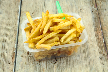 tray of french fries on a wooden table