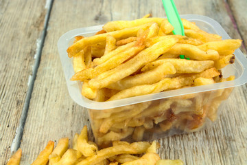 tray of french fries on a wooden table