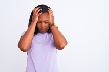 Beautiful young african american woman over isolated background suffering from headache desperate and stressed because pain and migraine. Hands on head.