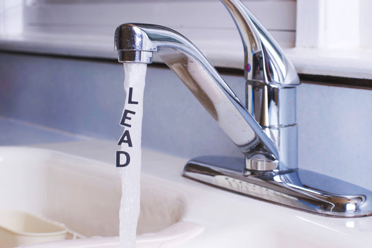 Lead in City tap water, actual lettering LEAD coming out of a stream of water from the kitchen faucet