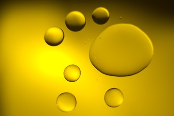 Yellow cooking Oil bubble and drops on water for background.