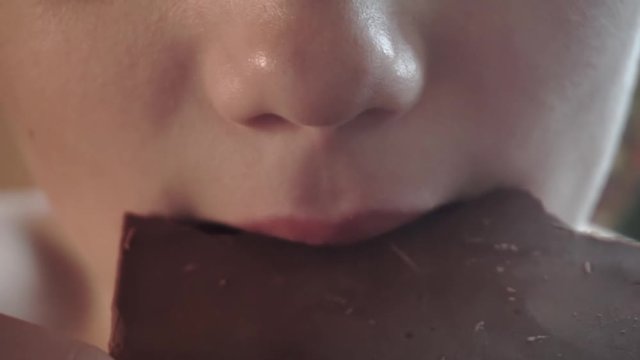 boy eating chocolate.children's mouth closeup