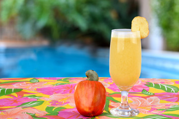 Cashew smoothie on colorful table with colorful blurred background.