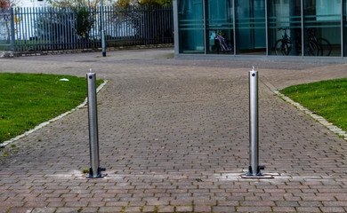 Two metal bollards on a path