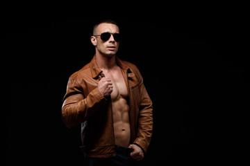 young handsome man, leather jacked on naked torso, emotional posing, lifestyle people concept