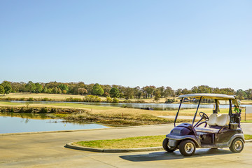 Empty golf cart by the club house while the player takes a break.