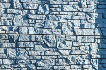 Stone white fence in the street in the yard in the village. Empty space for text