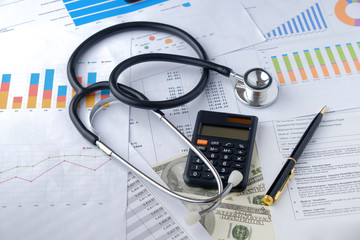 Stethoscope with Pen, Charts and Graphs, Finance, Account, Statistics, Investment, Analytic Research Data, Medical and Insurances Concept