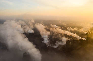Aerial view. Emission to atmosphere from industrial pipes. Smokestack pipes shooted with drone. Night scene