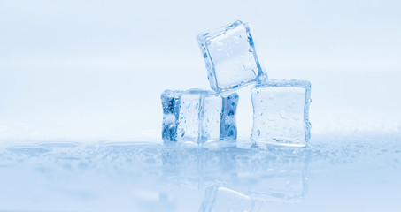 Naklejka na ściany i meble Ice cubes square with drops water clean on blue background banner