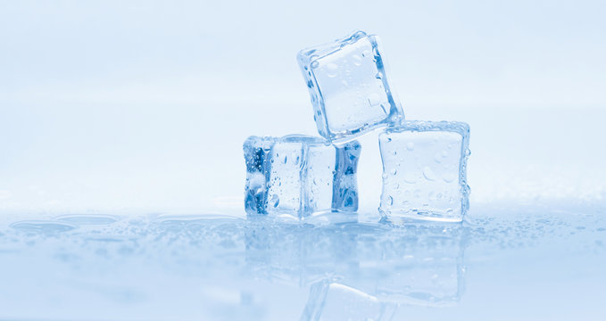 Ice cubes square with drops water clean on blue background banner
