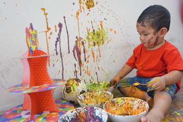 Asian boys one year and three months playing color mixing activities artist concept.