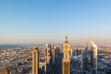 Aerial view of the iconic Sheikh Zayed road Skyscrapers and landmarks - Aerial view of Dubai city roads and Towers at sunset - Gevora Hotel view