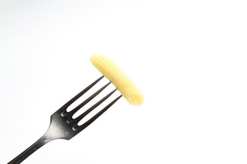 One pasta on a fork on a white background. close up