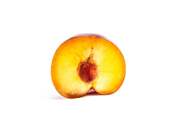Ripe red plum in a cut on a white background. close up