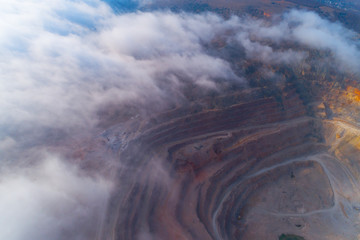 Aerial view of opencast mining quarry with lots of machinery at work - view from above.