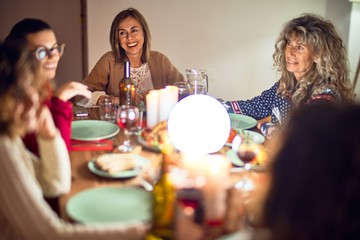Beautiful group of women smiling happy and confident. Eating roasted turkey celebrating thanksgiving day at home