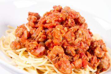 Spaghetti bolognese on a plate on a white background	