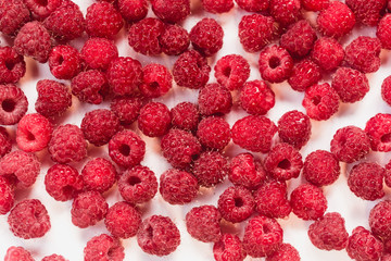 Dripping raspberry on white background.