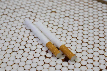 cigarette filters Empty cigarette paper top view Several white cigarettes (tubes) with yellow filters