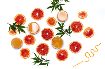 Grapefruit juice with marijuana with fruit slices flat lay