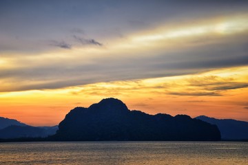 Islands Sunset, Ocean panorama views near Phuket with deep Red, Orange, Purple and Blue, mountains, twilight in Thailand. Including Phi Phi, Ko Rang Yai, Ko Li Pe and other islands. Asia.
