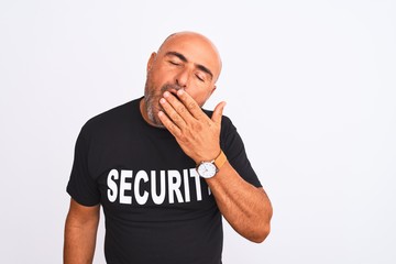 Middle age safeguard man wearing security uniform standing over isolated white background bored yawning tired covering mouth with hand. Restless and sleepiness.