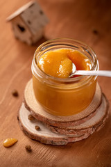 jar with honey on wooden background