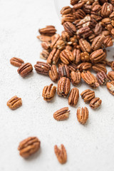 pecans scattered on a light background