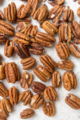 pecans scattered on a light background