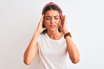 Young beautiful woman wearing casual t-shirt and diadem over isolated white background with hand on head for pain in head because stress. Suffering migraine.