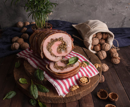 Pork Ham Stuffed With Walnuts And Spinach Wrapped In Bacon. Meatloaf With Nuts And Herbs. Festive Cuisine.