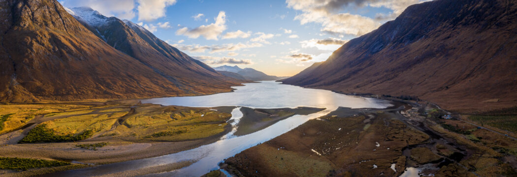 aerial panorama of glen etive and loch etive in the argyll region of the highlands of scotland during autumn and a golden sunset