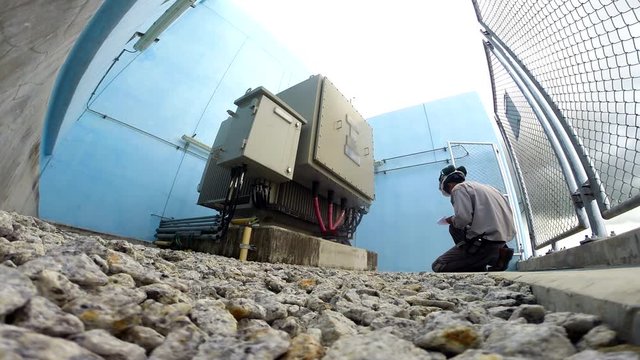 Electricians are checking daily on large transformers.