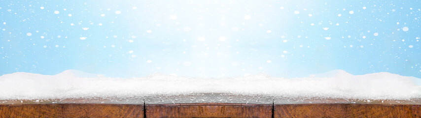 Christmas winter snow background banner - Snowy wooden rustic table - Background blue sky with...