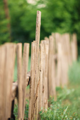 Old rural wooden fence made of natural boards of different sizes