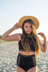 Cheerful plus size teenage girl wearing hat enjoying the beach. smiling, happy, positive emotion, summer style.