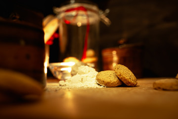 Christmas cookies with festive decoration on a rustic wooden table with colorful bokeh and copy space